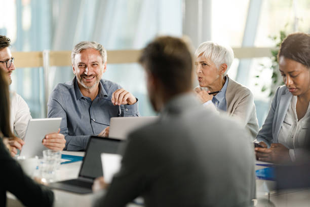 istock Happy entrepreneurs talking while having a meeting in the office. 2178817990