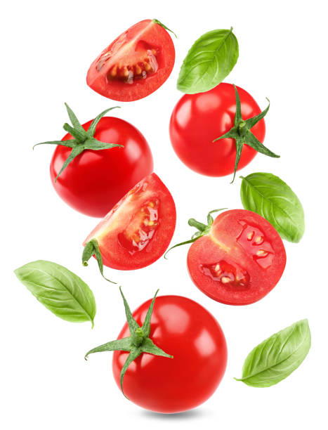 istock flying fresh tomatoes with green leaves isolated on white background. clipping path 2178819279