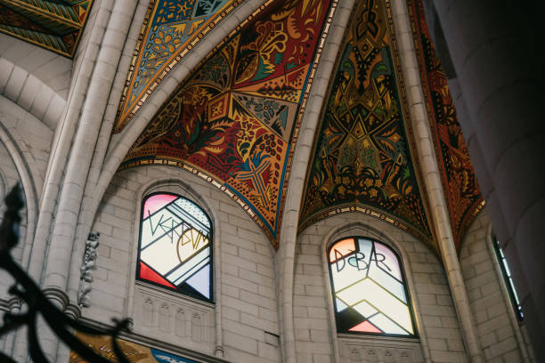 The colorful altarpiece of Madrid’s cathedral stands as a vibrant focal point, framed by soaring gothic arches. The intricate frescoes and stained glass windows add life and color to the sacred space, illustrating biblical scenes with a modern twist. The contrast between the white stone structure and the vivid artwork invites a deep sense of awe and reflection, embodying the rich history and evolving artistry of the cathedral. A perfect blend of tradition and contemporary expression, capturing the spiritual essence of Madrid’s architectural marvels.