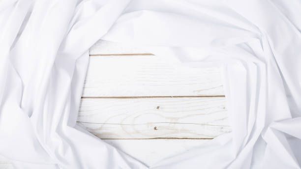 istock Cotton white fabric texture, abstract on wooden background. It has a soft look that like a wave suitable for background, backdrop. Copy space 2178821438