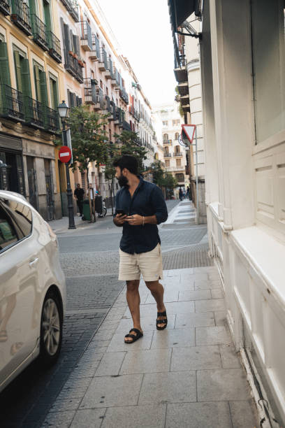 istock Man Checking for Car on Urban Street 2178821694