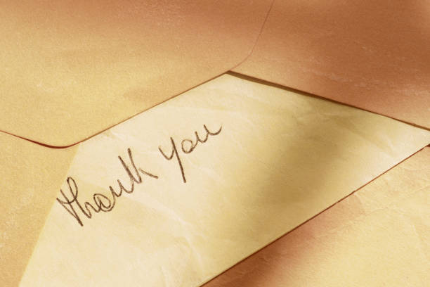 istock THANK YOU note on orange color paper 2178822660