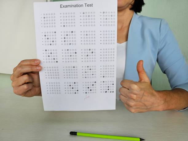 istock Person holding examination test sheet with various patterns and symbols 2178823495