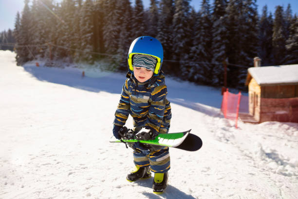 istock Boy preparing his skis for the slope 2178824833