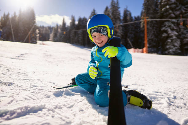 istock Boy preparing his skis for the slope 2178825005