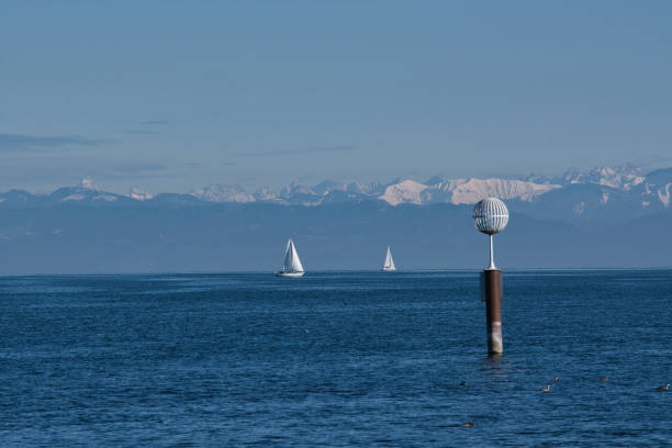 View of the harbor entrance of Meersburg on Lake Constance. The Austrian passenger ship Austria enters the harbor. The Swiss shore can be seen in the background.