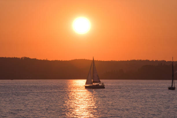 Single sailboat on the Lake Constance in the sunset