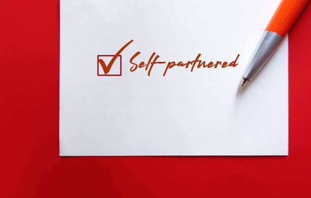istock Pen on torn note paper with handwriting SELF-PARTNERED - refers to relationship status fulfilled within self, not feel compelled to seek fulfillment through having another partner, positive single 2178828601