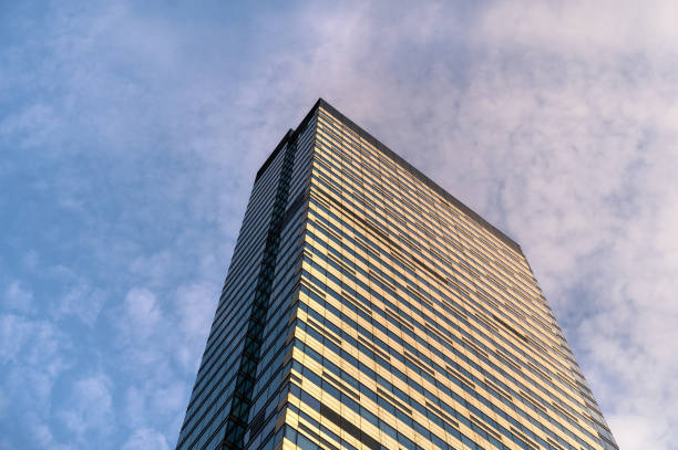 Angled view of modern skyscrapers in business district against blue sky. Looking Up high-rise office buildings.