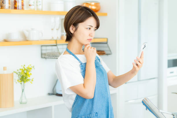istock Woman with smartphone in the kitchen 2178831165