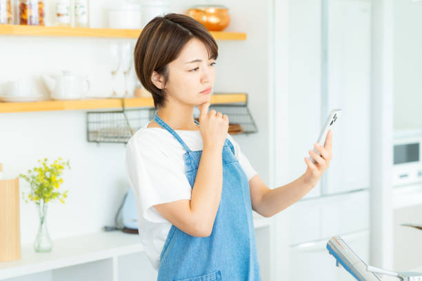 istock Woman with smartphone in the kitchen 2178831167