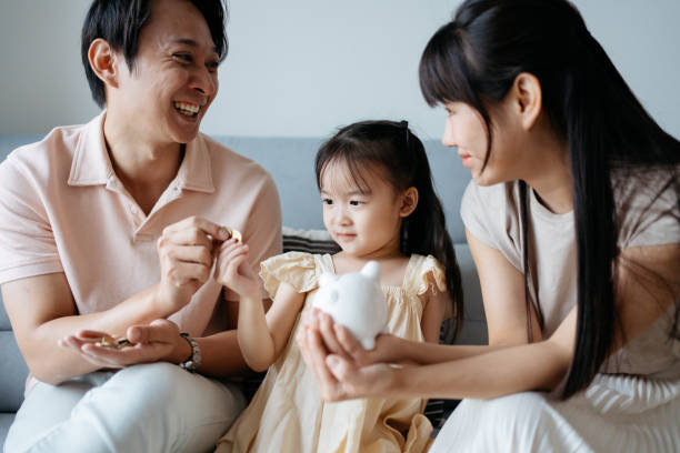 istock Asian parent teaches their daughter save money 2178833210