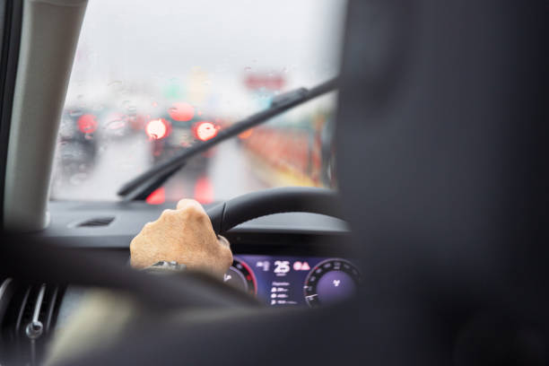 istock Rainy drive with blurred traffic lights, windshield wipers and overcast sky 2178833869