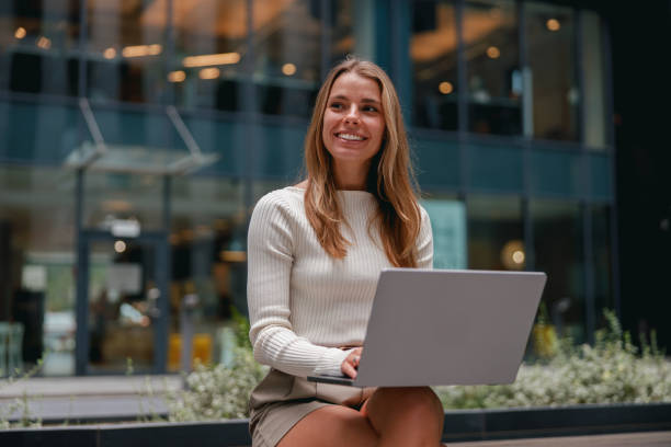 istock A cheerful woman is working diligently on her laptop in a modern office setting today 2178834976