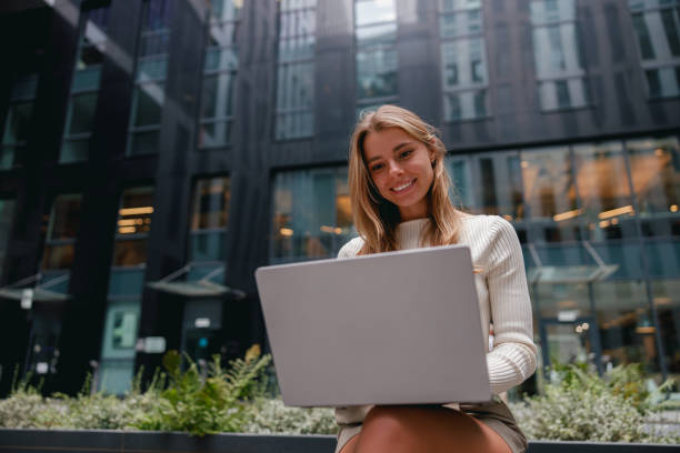 istock A young professional is working on a laptop in a modern urban setting, embracing creativity 2178835982