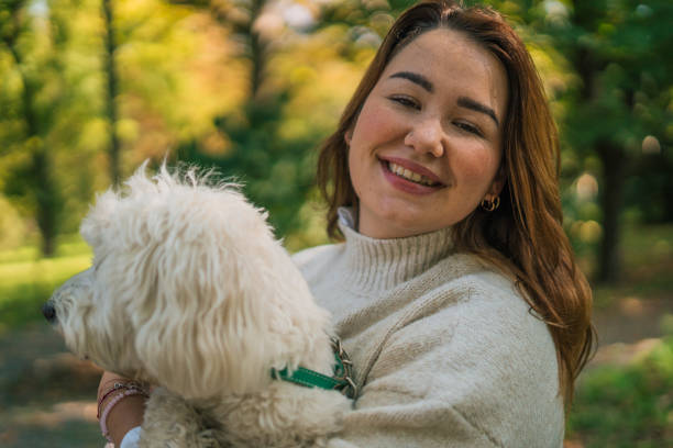 istock Young woman with dog, nature background 2178836546