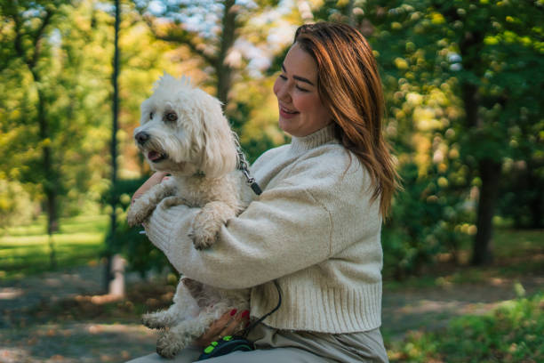 istock Young woman with dog, nature background 2178836975