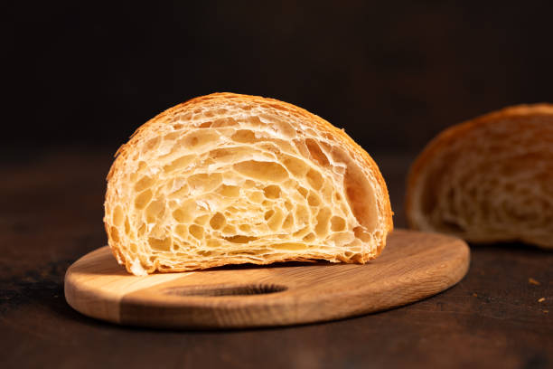 istock Cut in Half Croissant with Inside Texture and Thin Crisp Layers. Delicious French Pastry. Dark background. 2178837146