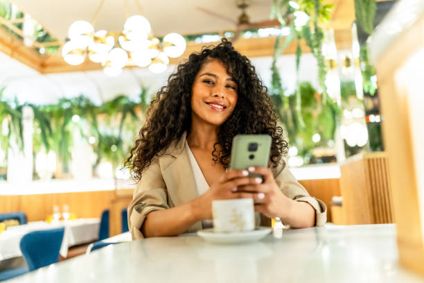 istock Happy beauty woman using smartphone in a cafeteria 2178837305