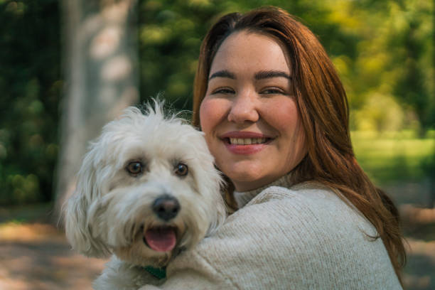 istock Young woman with dog, nature background 2178838345