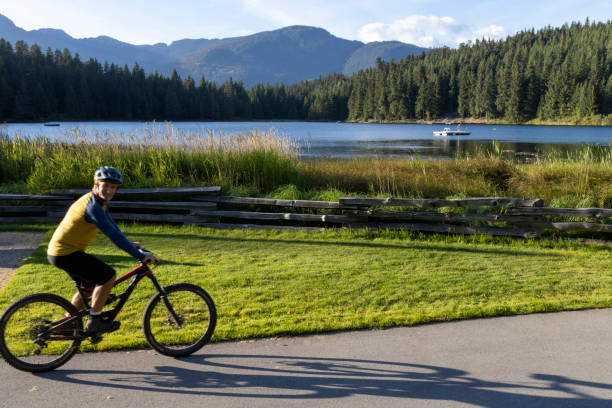 istock Mature man bicycles along lakeshore 2178838403
