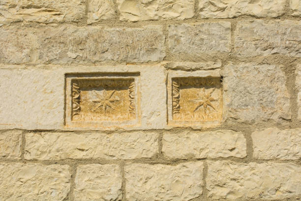 A close-up view of a red brick wall featuring a decorative vent, showcasing architectural detail and craftsmanship. The visual style is rustic and industrial, offering potential uses in design inspiration or construction contexts.