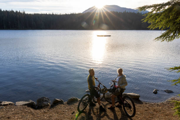 istock Mature couple with mountain bikes pause on lakeshore 2178839446