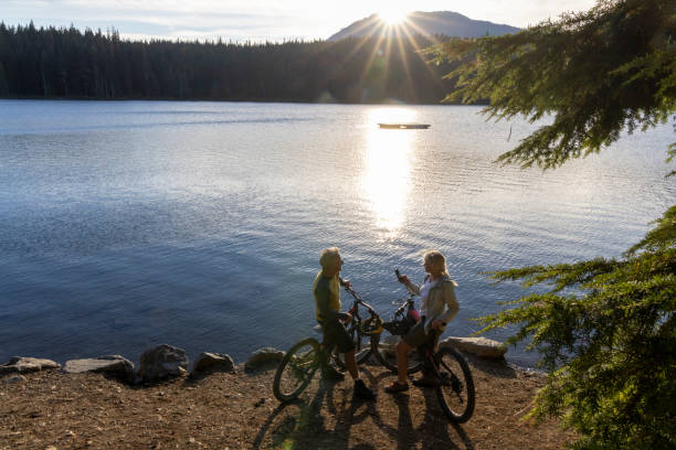 istock Mature couple with mountain bikes pause on lakeshore 2178839484