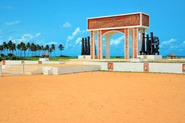 Ouidah / Whydah / Ajuda, Atlantique Department, Benin: the Gate of No Return at the end of the Slave Route, a memorial and symbol of the Transatlantic Slave Trade. Located along the coast of Ouidah, once a major slavery hub, The arch-shaped monument marks the symbolic final point where slaves would board ships bound for the Americas. The Gate commemorates the journeys of those who left, never to return, and serves as a reminder of the lasting impact of slavery in history.
