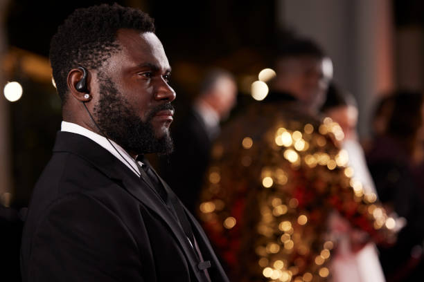 istock Security member stands alert, watching the events unfold on the red carpet. 2178843170