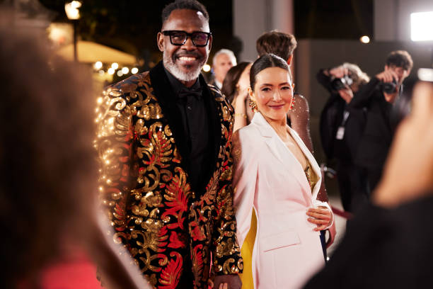 istock From the fans' perspective, celebrities smile and pose while working the red carpet, captivating the crowd. 2178843197