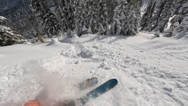istock Skier descends mountain in fresh powder snow 2178843221