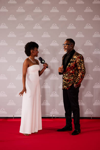 istock A movie star stops on the red carpet before the step and repeats the wall, ready for an interview with a reporter. 2178843308