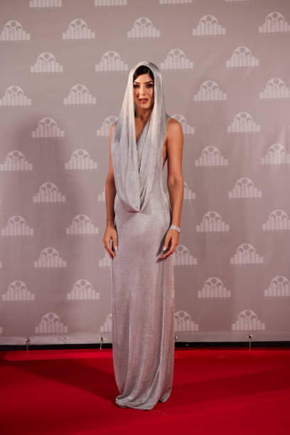 istock The actress confidently poses at the red carpet arrival line. 2178843351