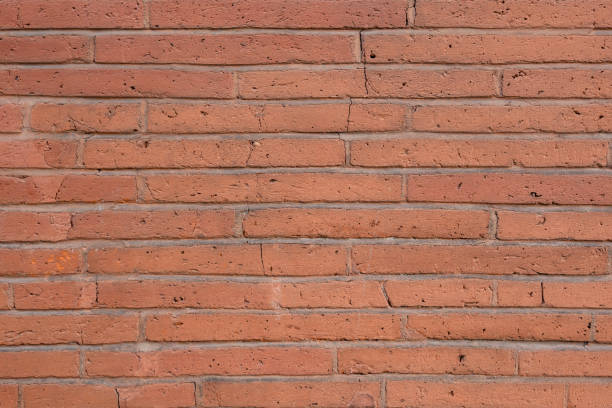 A textured brick wall background with warm hues, evoking nostalgia and charm for art