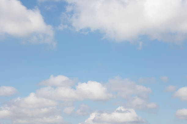 A beautifully serene view showcasing fluffy clouds against a bright blue sky, ideal for various naturethemed projects