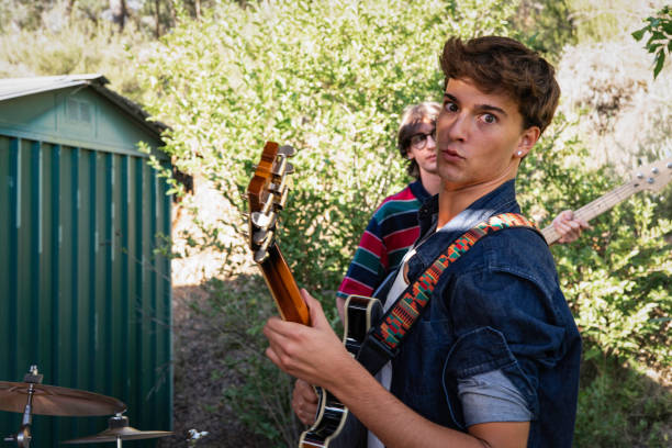 Young friends rehearsing with the music band in the shed