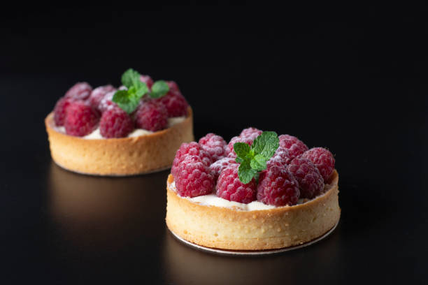 istock Tarts with fresh raspberries on black background 2178849090