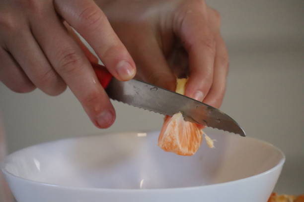 istock Young female hands manipulate tangerine 2178849346