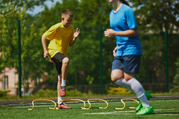 istock Youth Sports Training. Competitive children, boys in uniform training outdoors, doing exercises with agility ladder. 2178851554