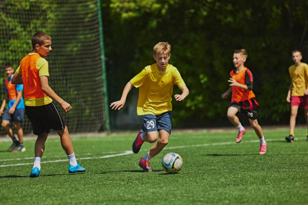 istock Dynamic Sports Training. Young soccer players practicing dribbling and passing skills during outdoor game. Coordination and sportsmanship. 2178851558