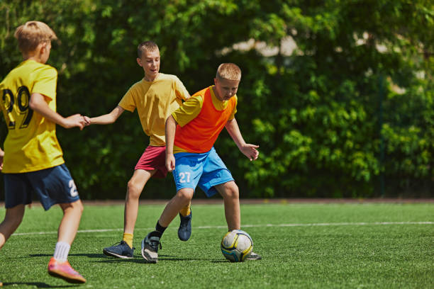 istock Energetic Team Play. Young athletes in uniform training, playing with focus and determination on outdoor field on sunny day. 2178851567