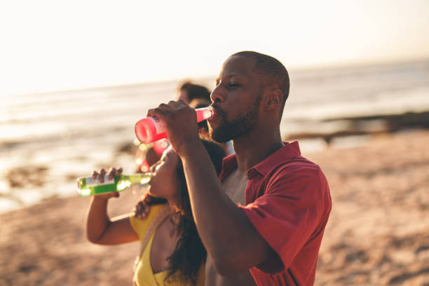 istock Couple having a drink at the beach 2178853564