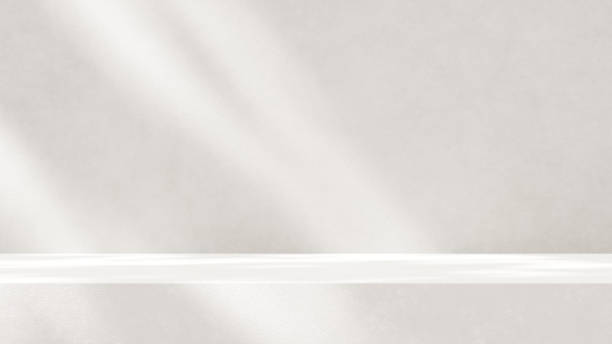 istock Minimalistic, simple, and light background for product presentation. Streaming sunlight casts soft shadows from a window onto a white-gray wall and floor, creating a clean and elegant atmosphere. 2178856411