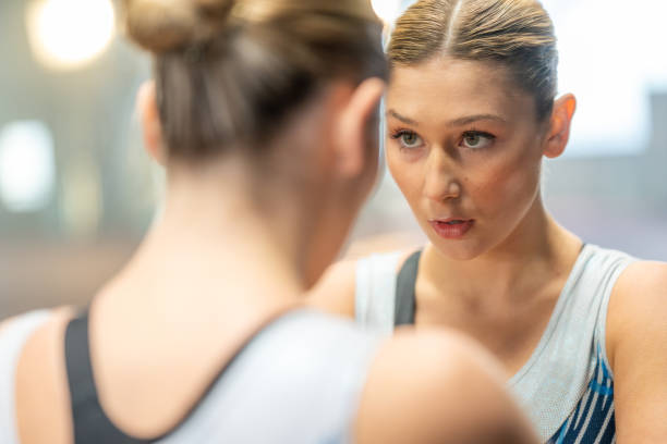 Gymnast woman looking in mirror