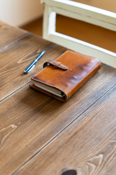 istock Ring bound planner and pen on wooden table 2178858121