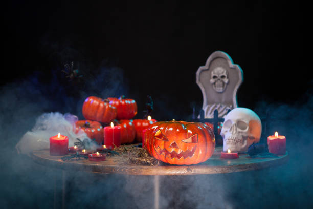 istock Different halloween symbols on a wooden table with smoke 2178859774