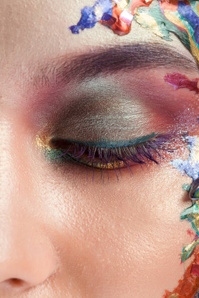 istock Beautiful woman with creative makeup on her face in studio 2178862739