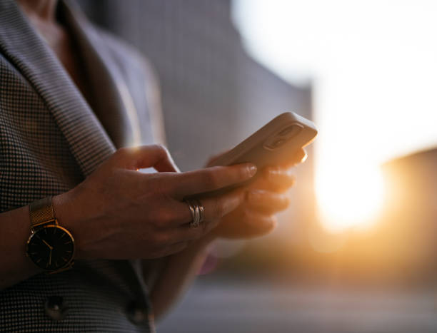 istock Businesswoman Using Smartphone Outdoors During Sunset 2178863040