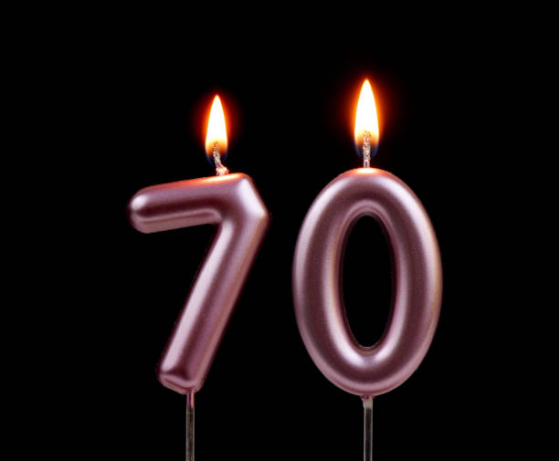 istock Pink birthday candles isolated on black background, number 70 2178864450